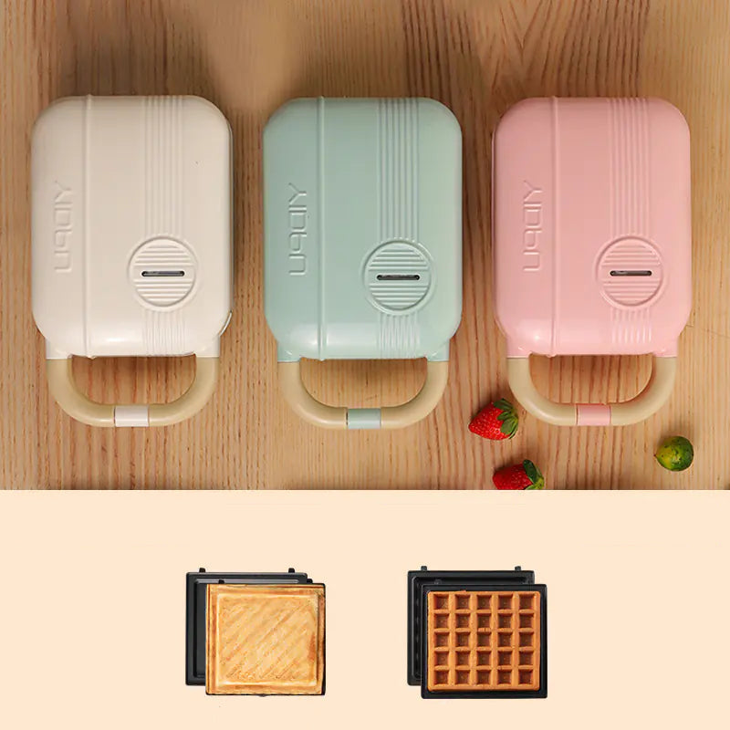 Living Abroad Creations 3-in-1 Breakfast Maker in green, pink & white on a kitchen countertop