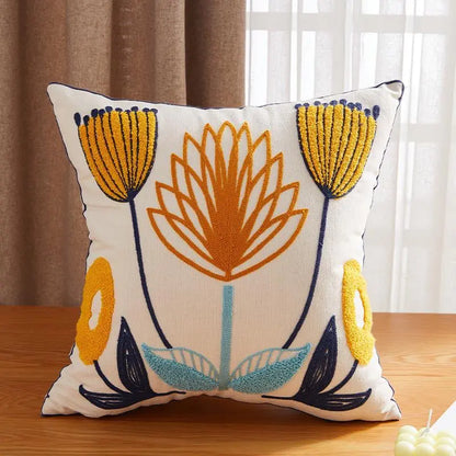 Living Abroad Creations floral throw pillow with blue accents in a cozy reading nook