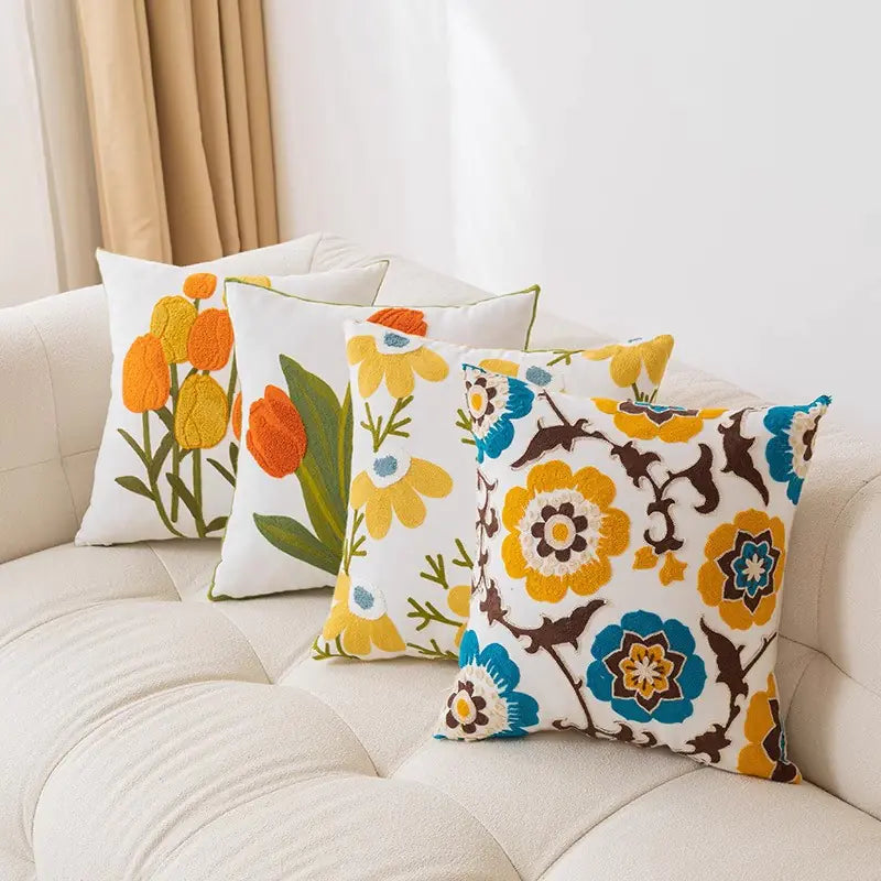 Living Abroad Creations floral throw pillows on a a cozy couch