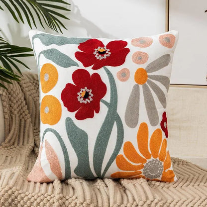 Living Abroad Creations red and yellow floral embroidered pillow with soft lighting