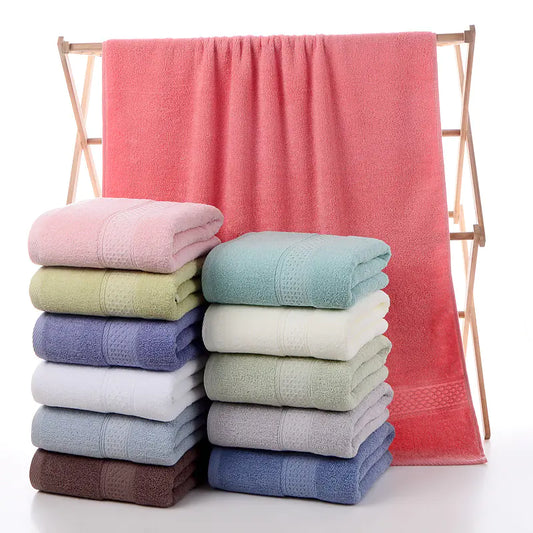 Luxury cotton towels folded neatly on bathroom shelf – Living Abroad Creations